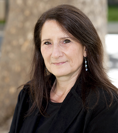 Woman shhoulder length brown hair wearing a dark outfit