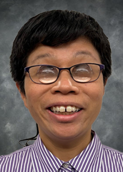 Female with short brown hair and purple rimmed prescription glasses