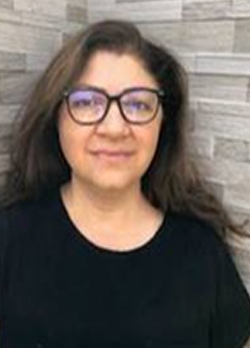 Woman with medium length, brown hair wearing prescription glasses and a black t-shirt