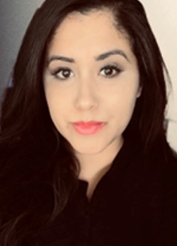 Woman with dark brown hair wearing a black shirt