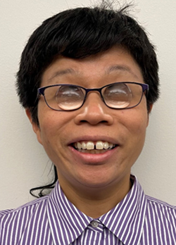 Man with black hair wearing prescription glasses and a striped purple shirt